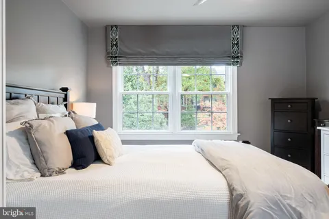 a bedroom with a bed and a television