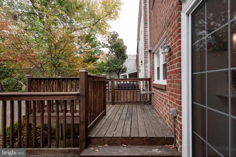 a backyard of a house with barbeque oven table and chairs