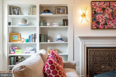 a living room with baby toys and a book shelf