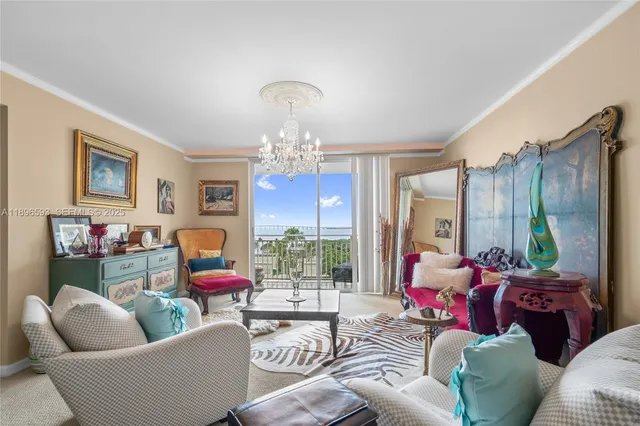 a living room with furniture chandelier and a large window