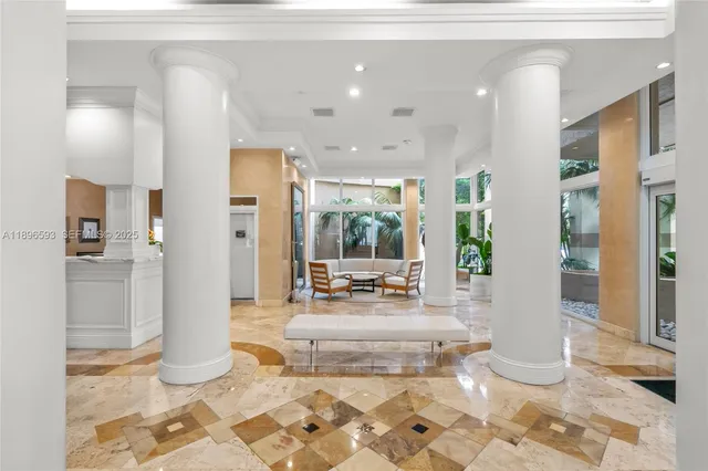 a living room with a large window and white walls