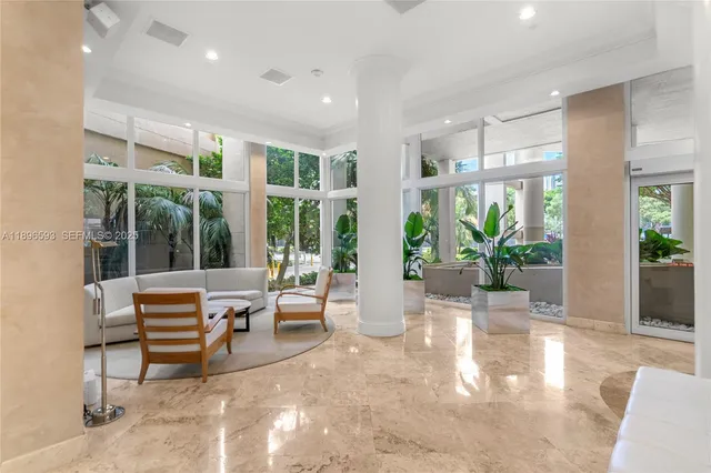 a living room with furniture and large windows