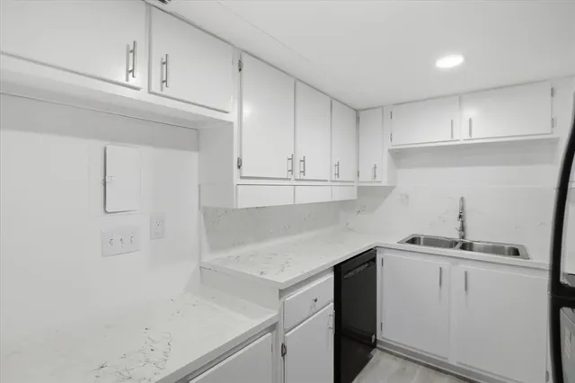 a kitchen with a sink cabinets and appliances