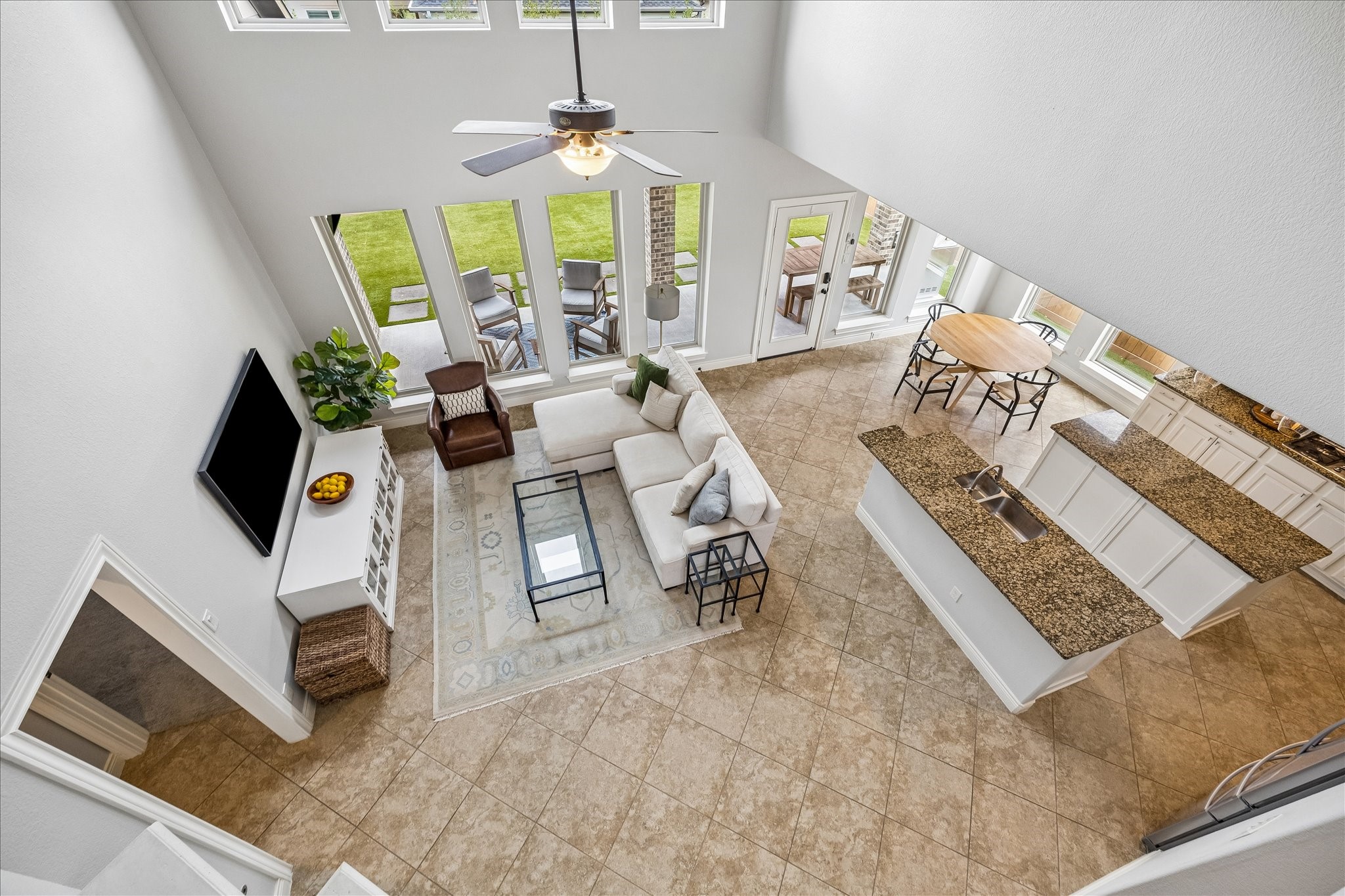 1616 Hewitt Drive Houston, TX 77018 - Photo 16 of 44 View from the upstairs landing showcases the impressive scale of the living room below, where oversized windows flood the space with natural light.