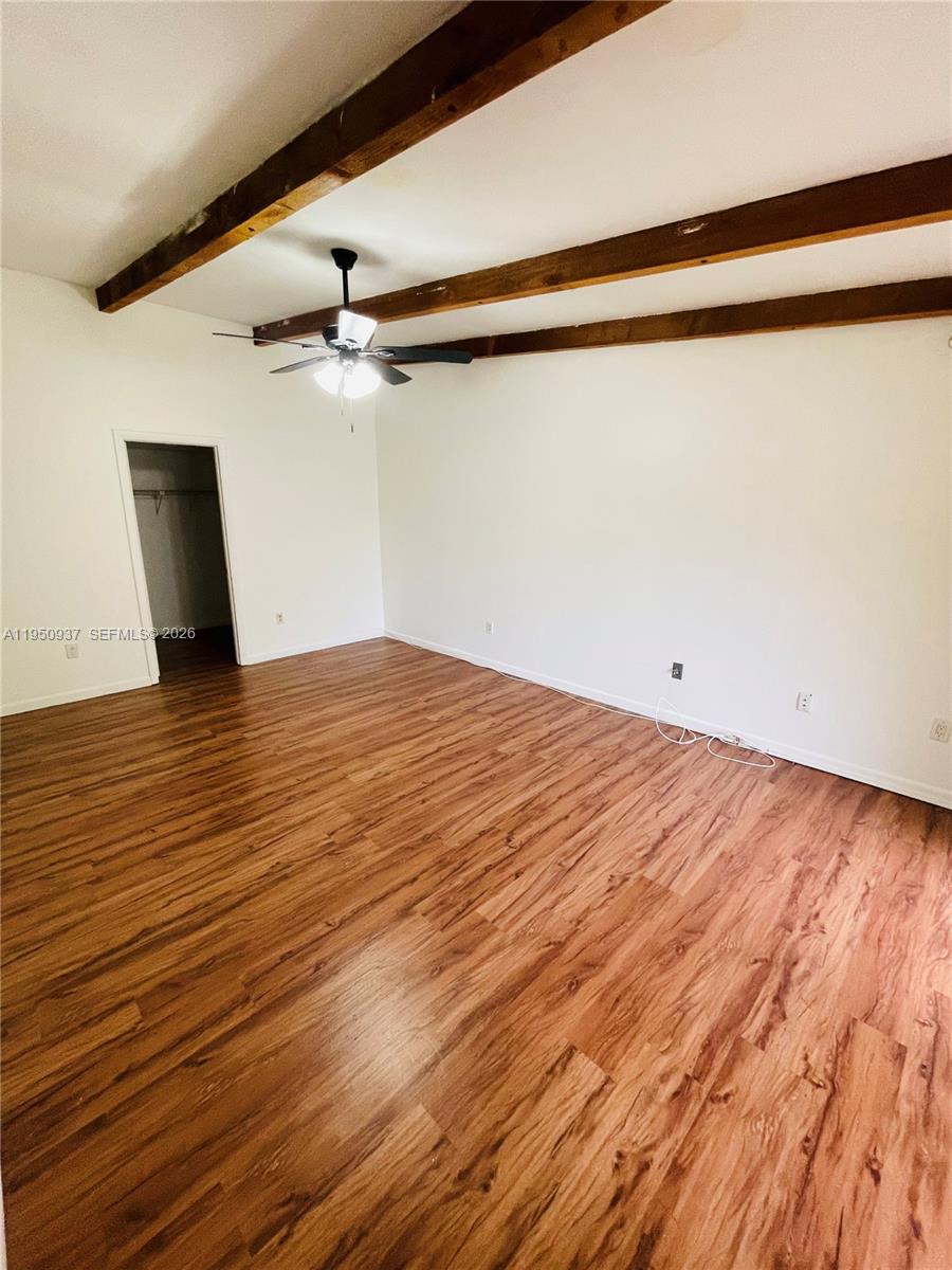 6425 Southwest 116th Place, Unit E Miami, FL 33173 - Photo 14 of 16 a view of empty room with wooden floor