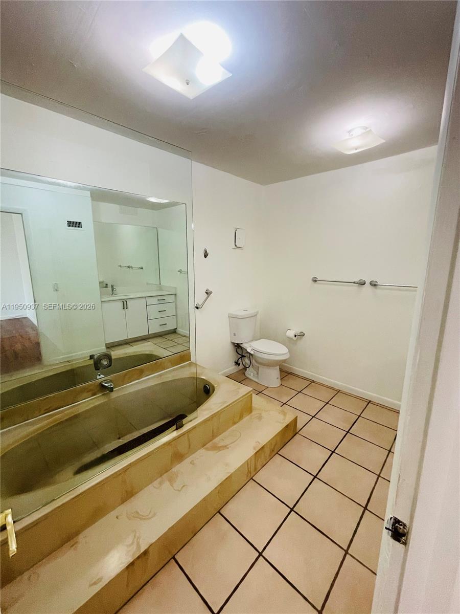 6425 Southwest 116th Place, Unit E Miami, FL 33173 - Photo 15 of 16 a bathroom with a sink and a mirror