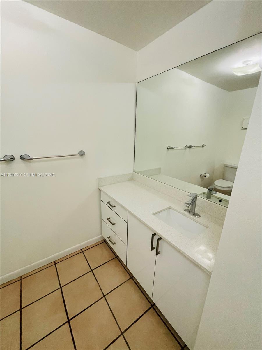 6425 Southwest 116th Place, Unit E Miami, FL 33173 - Photo 16 of 16 a bathroom with a sink and a mirror