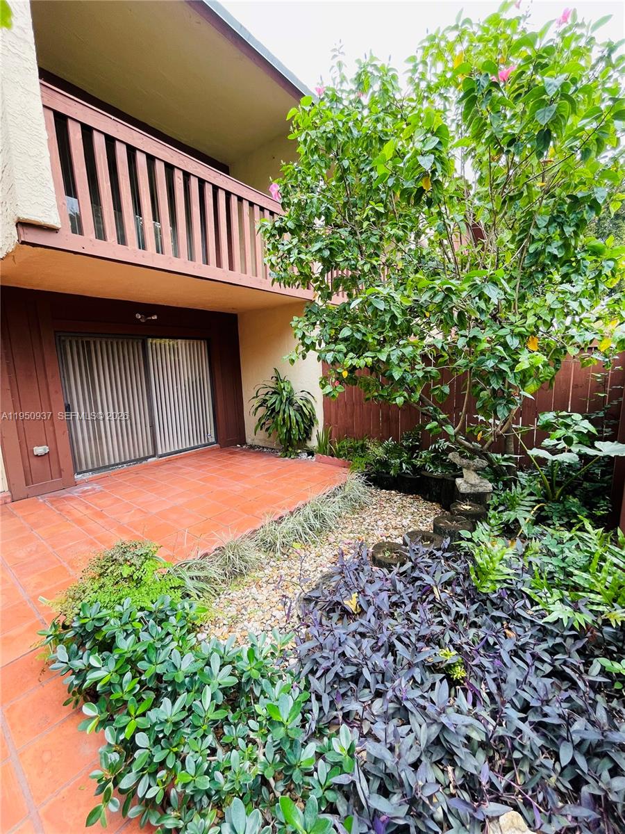 6425 Southwest 116th Place, Unit E Miami, FL 33173 - Photo 2 of 16 a view of a backyard with a garden