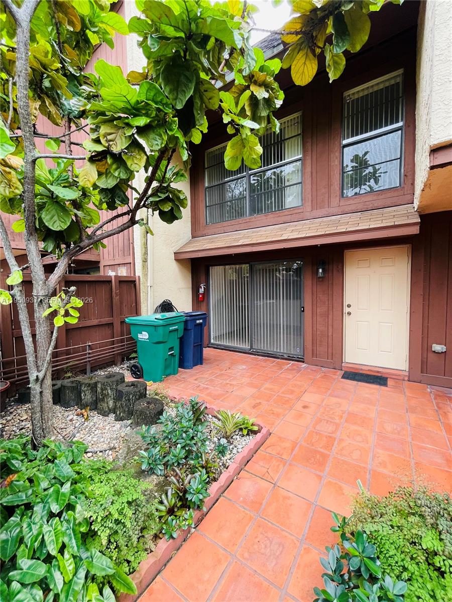 6425 Southwest 116th Place, Unit E Miami, FL 33173 - Photo 3 of 16 a front view of a house with garden