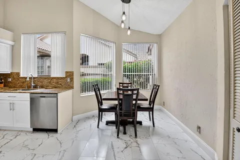 a dining room with furniture and window