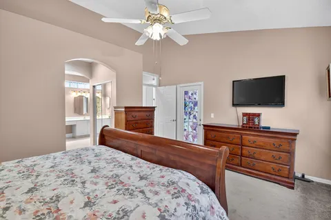 a bedroom with a bed and a flat screen tv