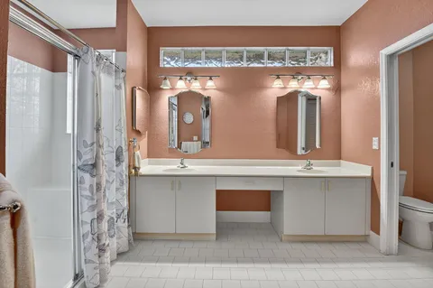 a bathroom with a double vanity sink and mirror