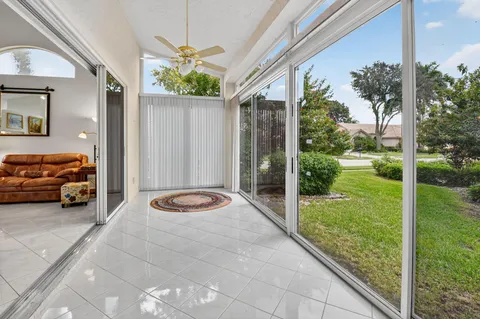 a view of a porch with furniture and garden