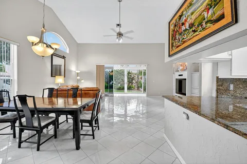 a view of a dining room with furniture and chandelier