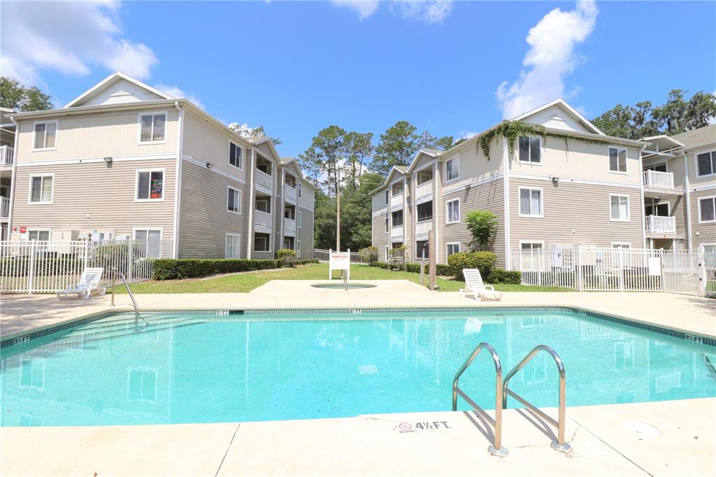 4000 Southwest 23rd Street, Unit 5207 ROOM B Gainesville, FL 32608 - Photo 1 of 23 a view of a house with swimming pool and a yard