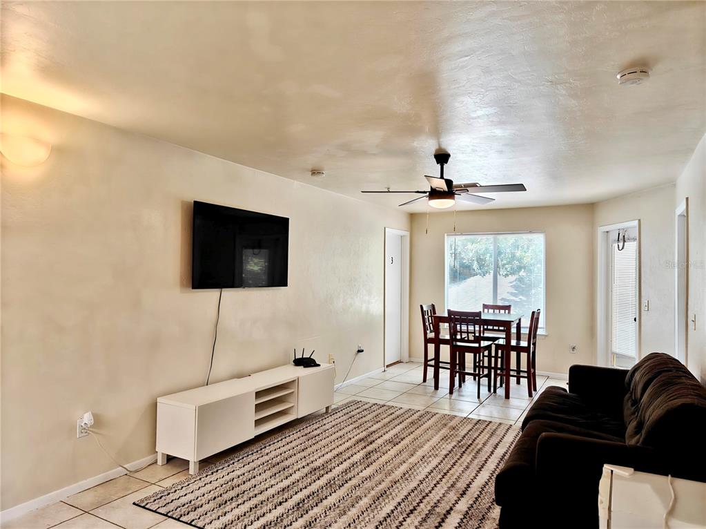 4000 Southwest 23rd Street, Unit 5207 ROOM B Gainesville, FL 32608 - Photo 12 of 23 a living room with furniture and a flat screen tv