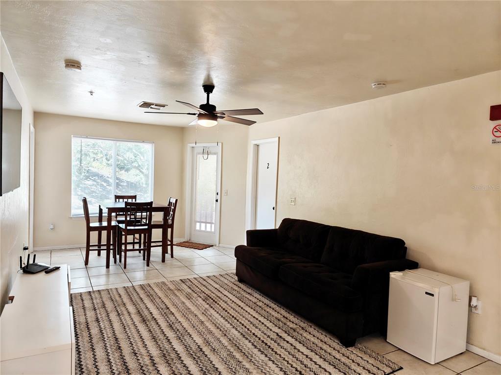 4000 Southwest 23rd Street, Unit 5207 ROOM B Gainesville, FL 32608 - Photo 16 of 23 a living room with furniture and a wooden floor