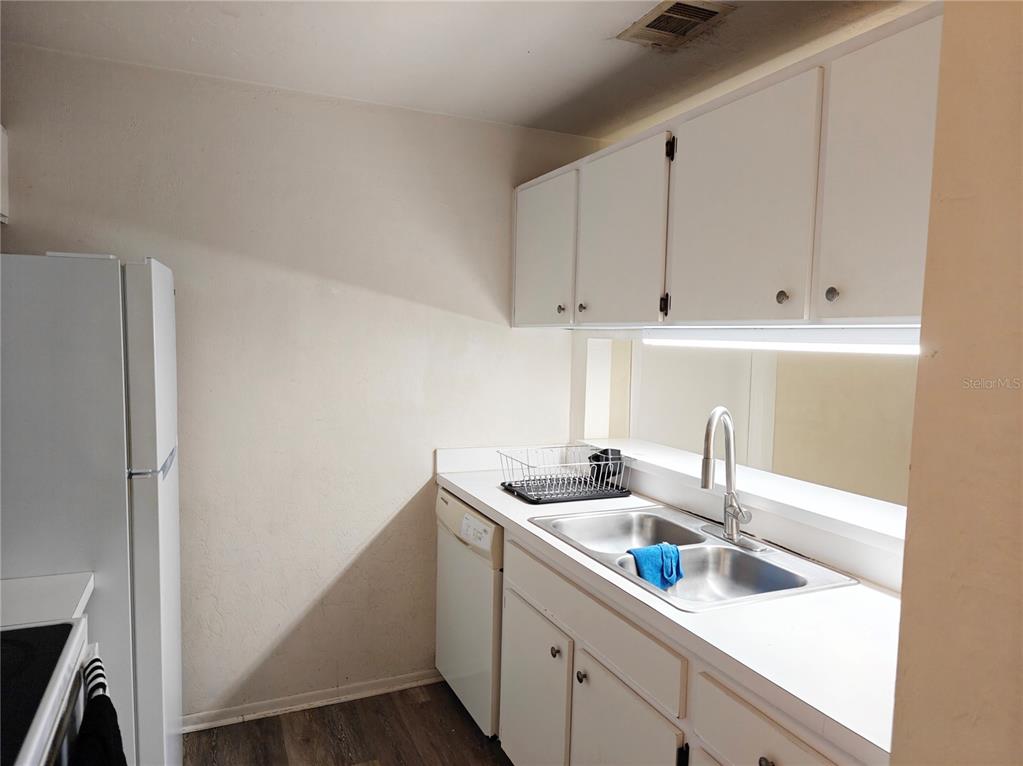 4000 Southwest 23rd Street, Unit 5207 ROOM B Gainesville, FL 32608 - Photo 18 of 23 a kitchen with a sink and cabinets