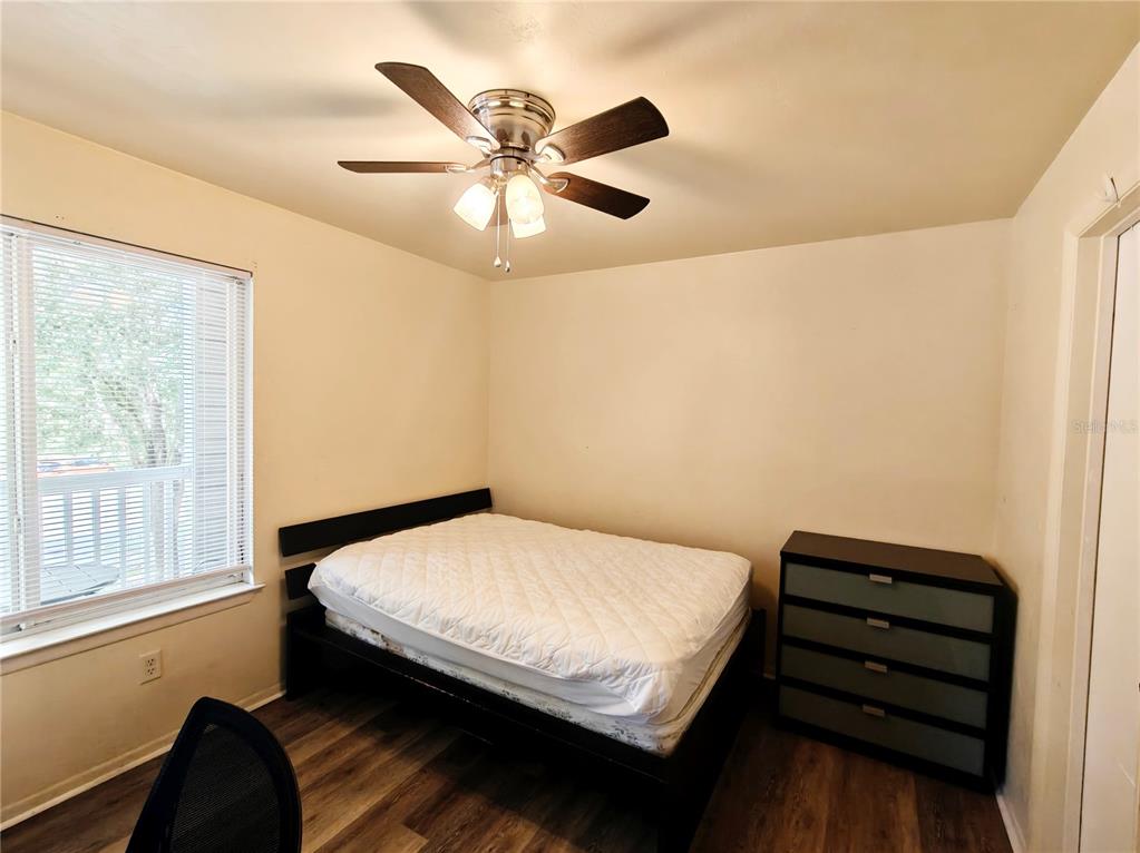 4000 Southwest 23rd Street, Unit 5207 ROOM B Gainesville, FL 32608 - Photo 3 of 23 a bedroom with a bed and wooden floor