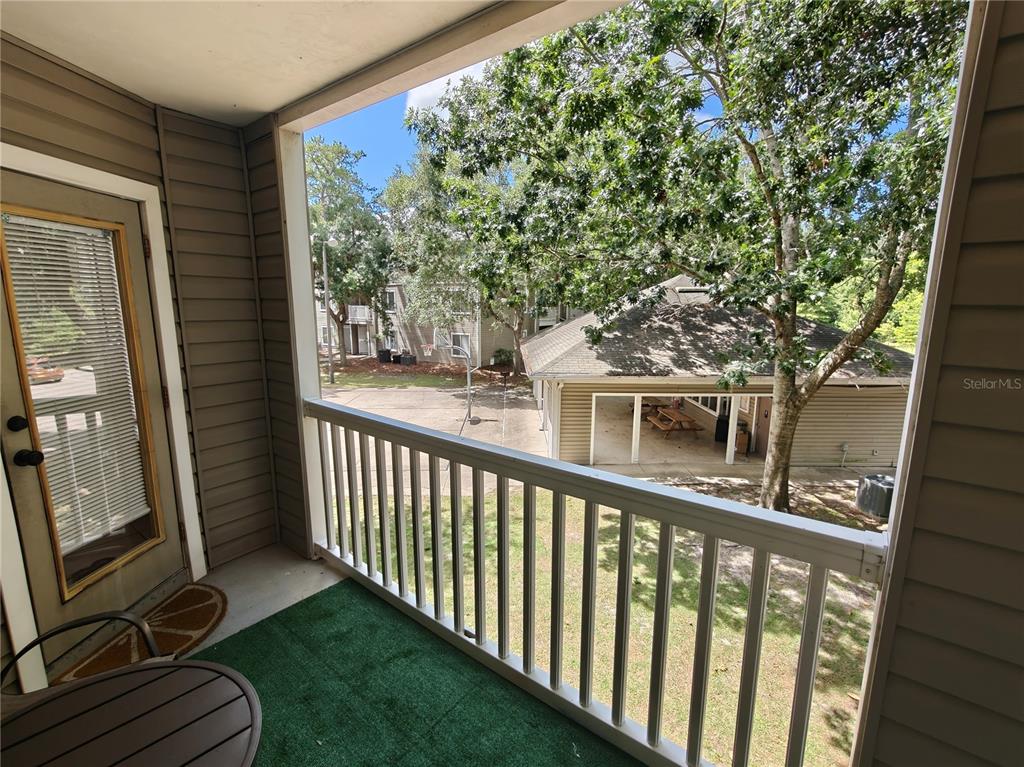 4000 Southwest 23rd Street, Unit 5207 ROOM B Gainesville, FL 32608 - Photo 9 of 23 a view of a balcony with wooden floor