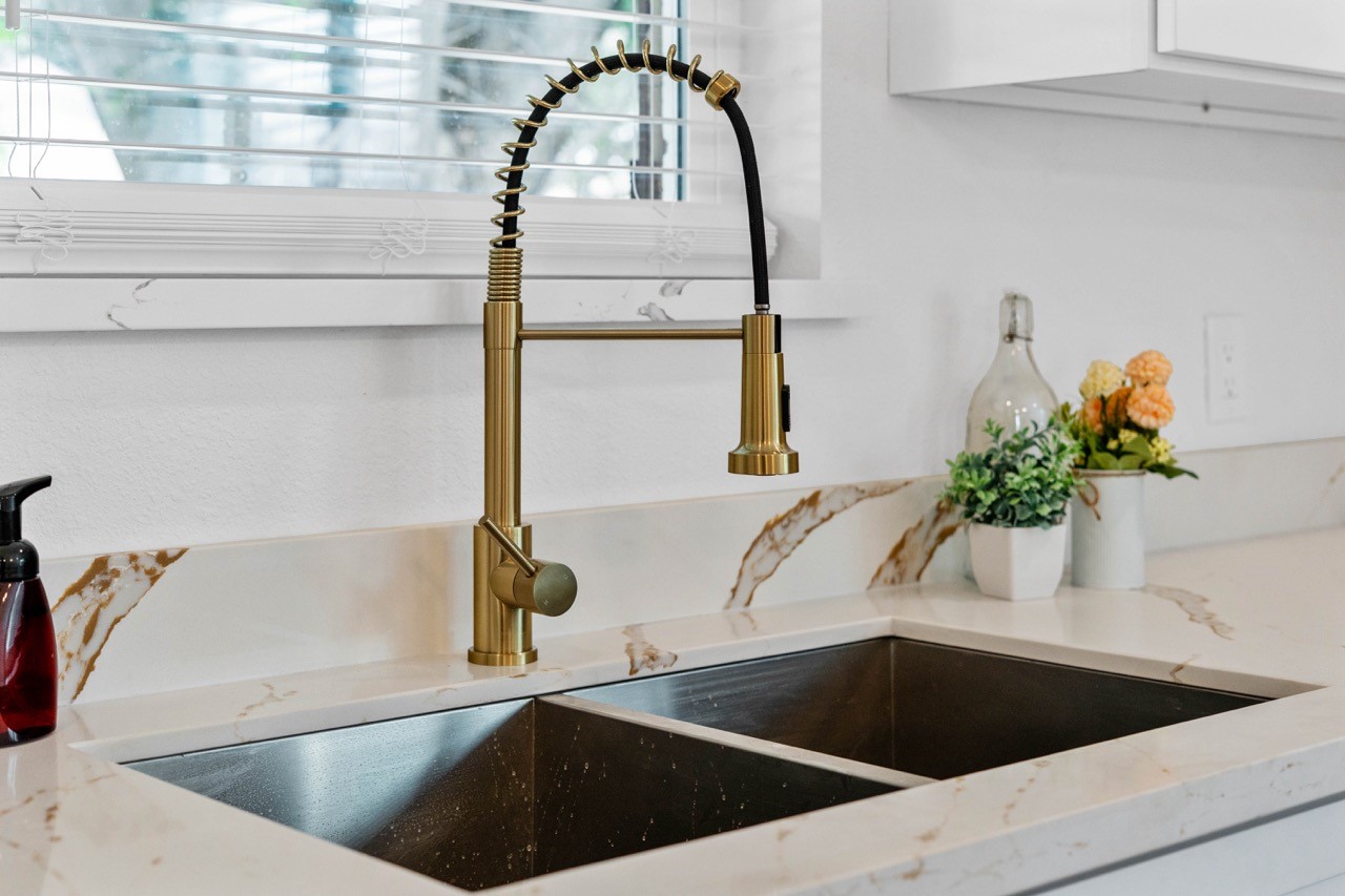 5326 Findlay Drive Pasadena, TX 77505 - Photo 19 of 50 Farmhouse-style workstation sink with a designer pull-down faucet and quartz countertops.