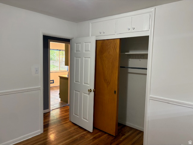2313 150 East Bountiful, UT 84010 - Photo 14 of 39 Hardwood-style flooring throughout, featuring a functional closet with sliding wood-panel door and upper cabinetry