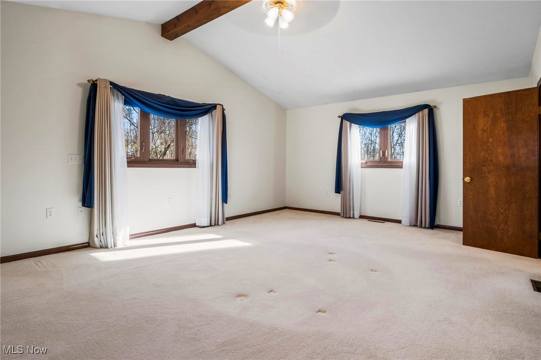 3290 State Rte 534 Geneva, OH 44041 - Photo 16 of 43 Carpeted empty room featuring vaulted ceiling with beams and ceiling fan
