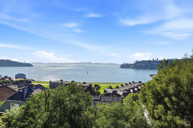 a kitchen with granite countertop a sink a stove and cabinets