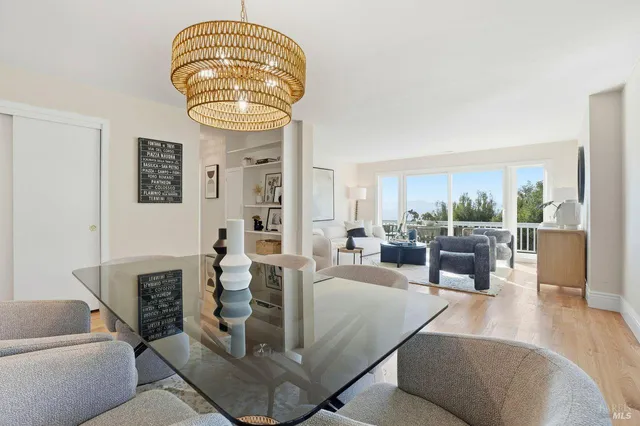 a bedroom with furniture and a large window