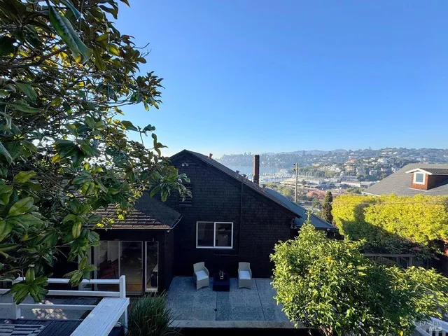 a living room with furniture a large window and a large mirror
