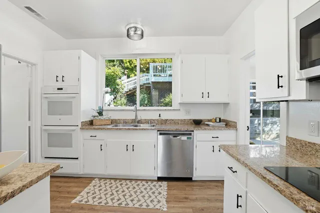 a bedroom with a bed and a table with wooden floor