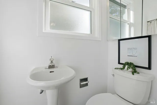 a living room with furniture a fireplace and a floor to ceiling window