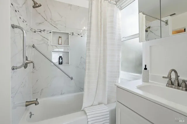 a kitchen with stainless steel appliances granite countertop a sink refrigerator and cabinets