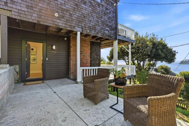 a group of people sitting in a yard in front of a store