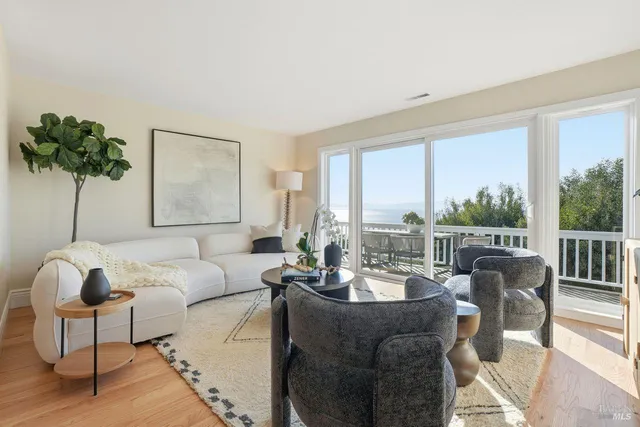 a living room with furniture and a mirror