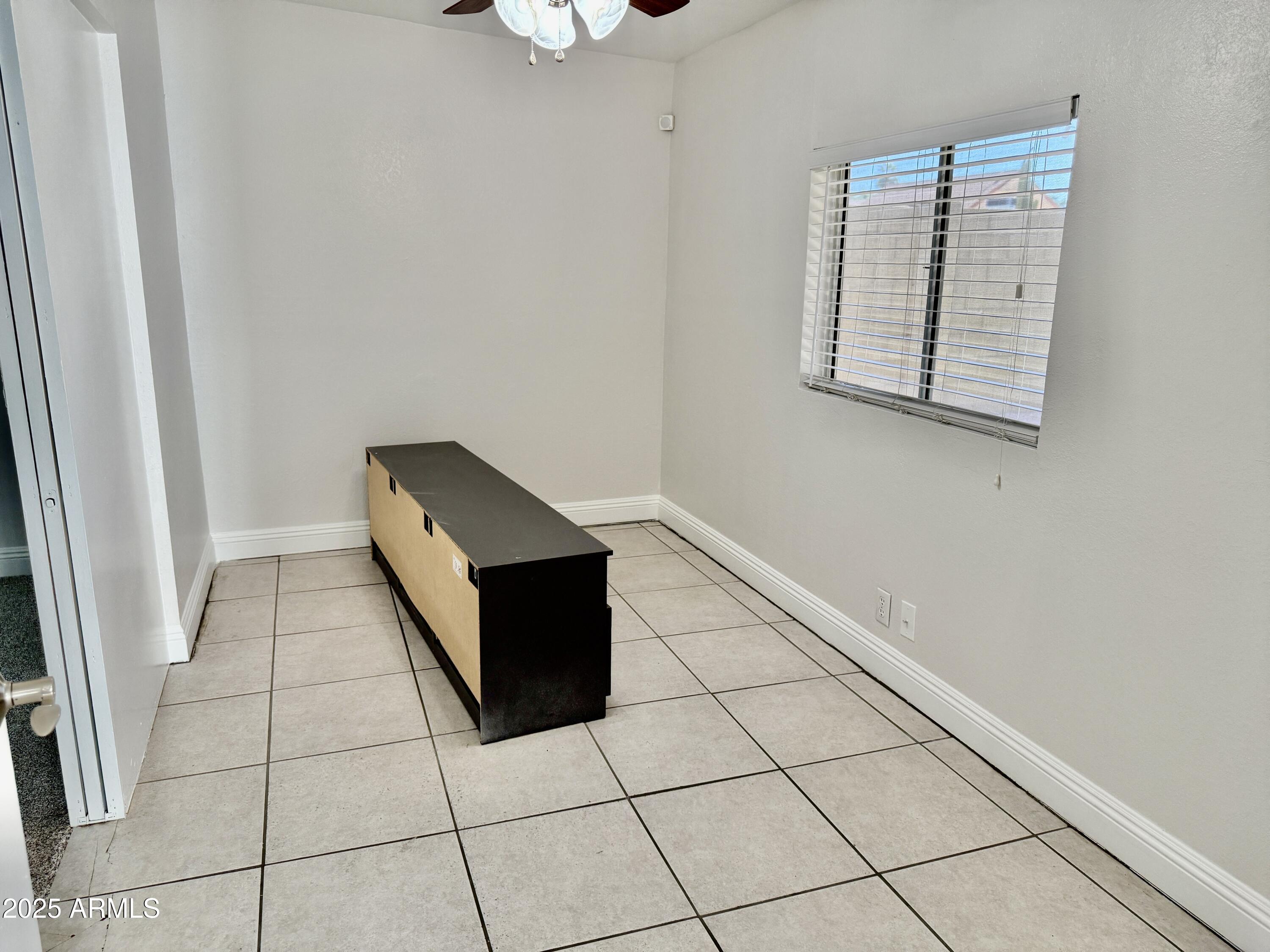 1213 East Tonto Lane Phoenix, AZ 85024 - Photo 12 of 19 an empty room with wooden floor and windows