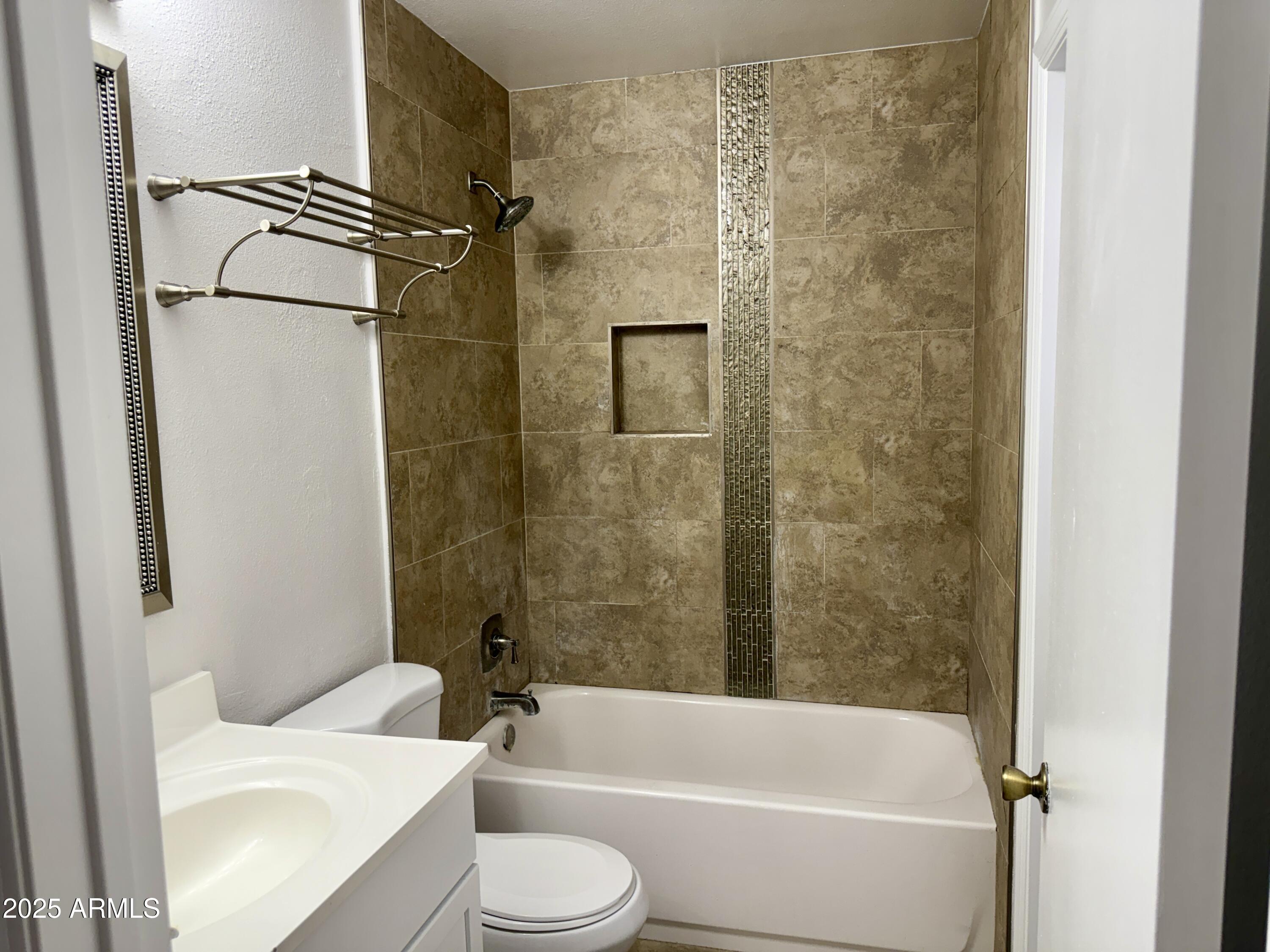 1213 East Tonto Lane Phoenix, AZ 85024 - Photo 17 of 19 a bathroom with a toilet a sink and bathtub