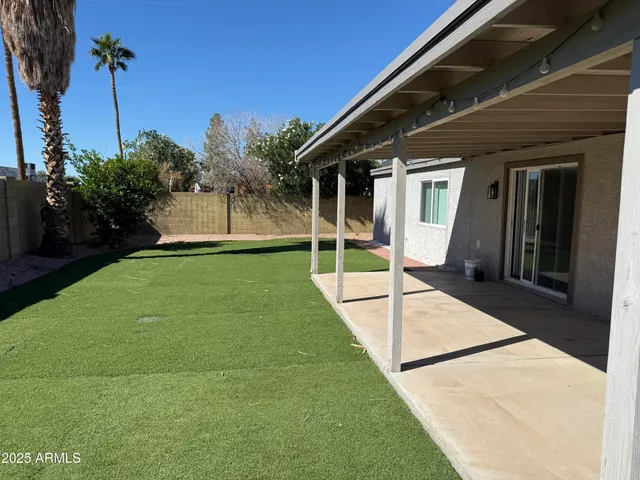 a view of a house with backyard and porch