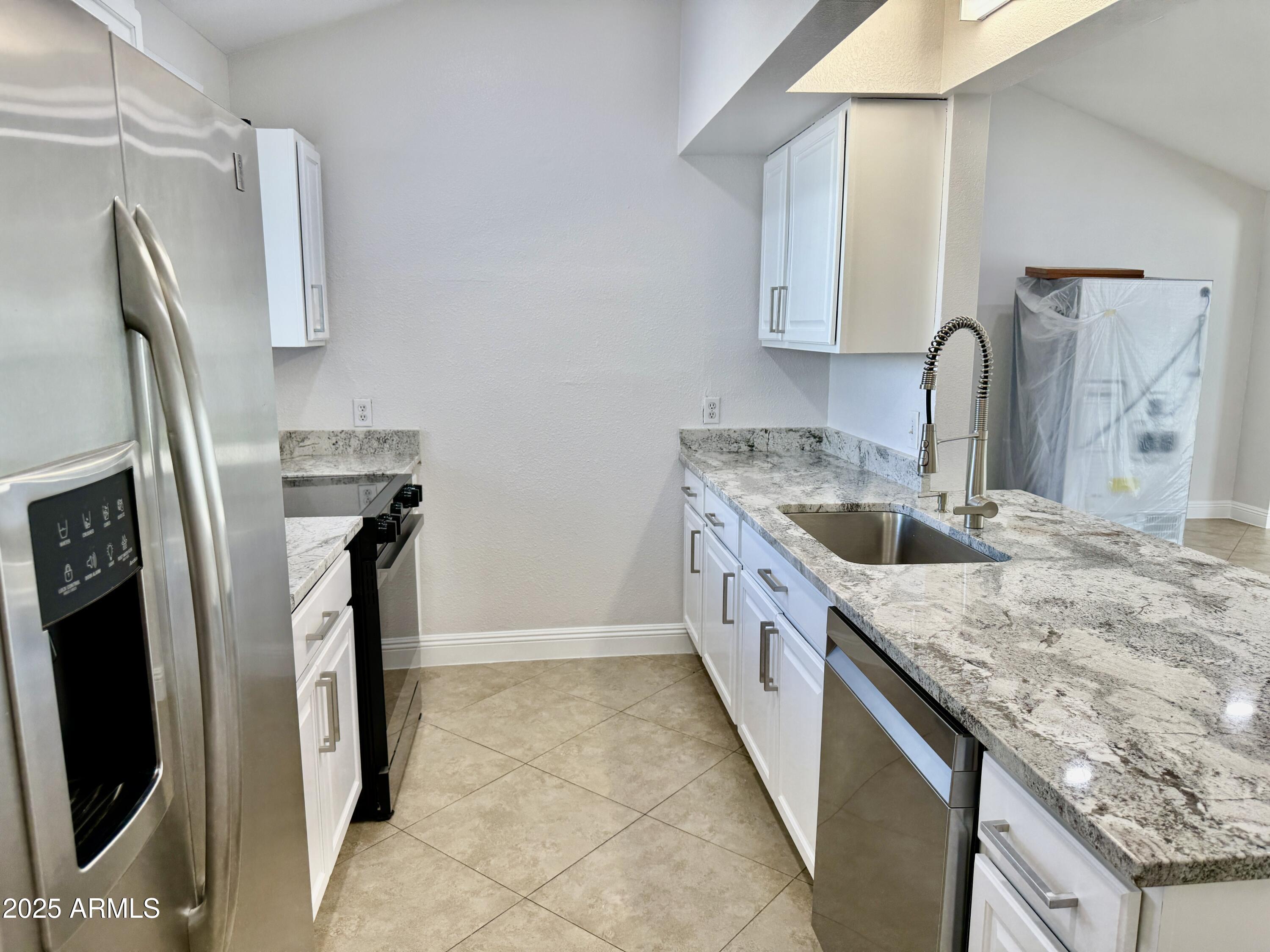 1213 East Tonto Lane Phoenix, AZ 85024 - Photo 4 of 19 a kitchen with stainless steel appliances granite countertop a sink stove and refrigerator