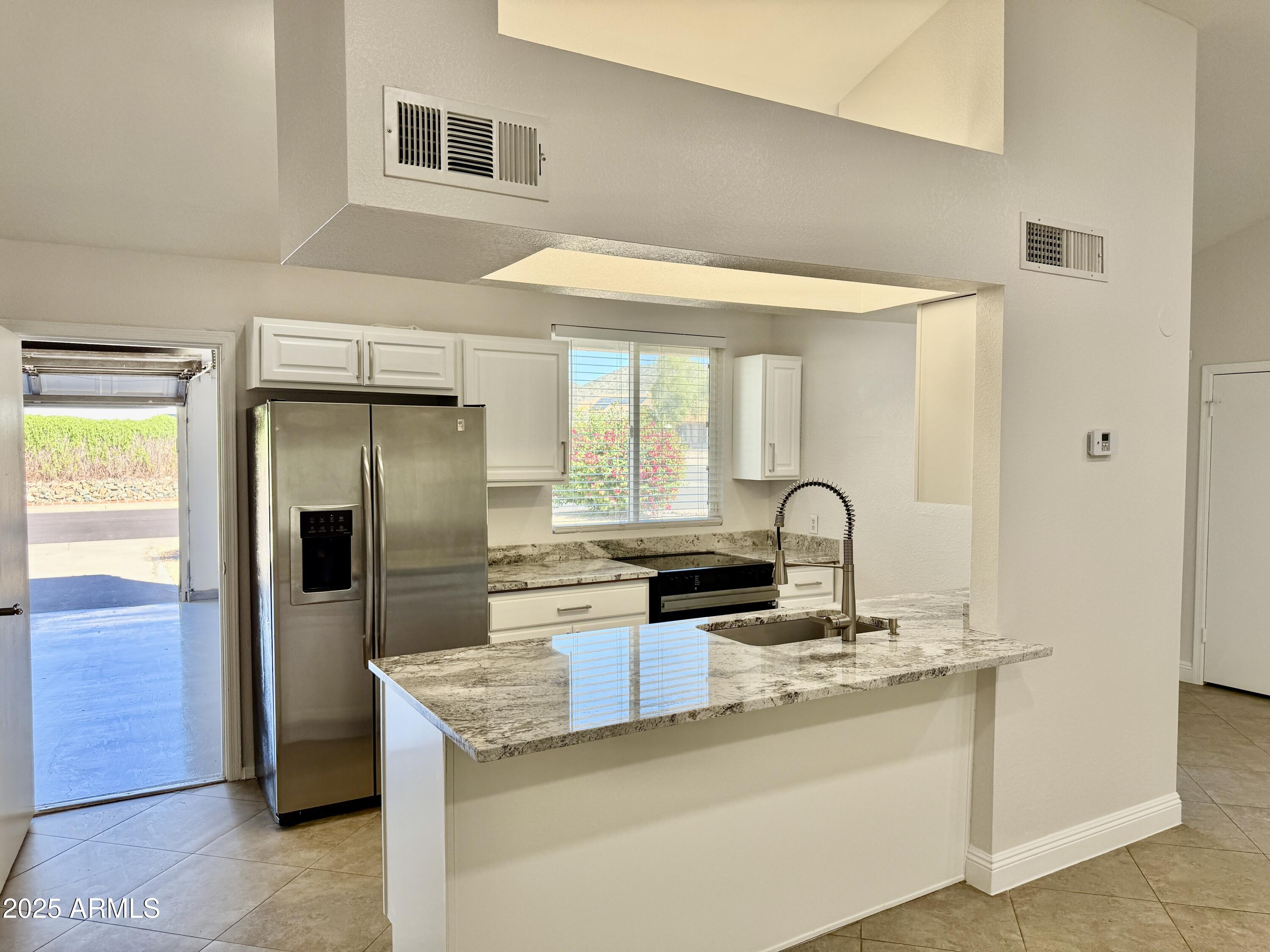 1213 East Tonto Lane Phoenix, AZ 85024 - Photo 5 of 19 a kitchen with stainless steel appliances granite countertop a refrigerator and a stove