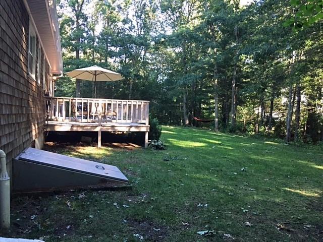 196 Capn Crosby Road Centerville, MA 02632 - Photo 22 of 25 a view of a house with backyard wooden deck and sitting area