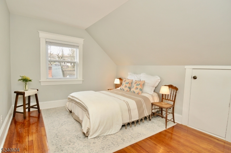 44 Dunnell Road Maplewood, NJ 07040 - Photo 15 of 17 a bedroom with a bed and a chair