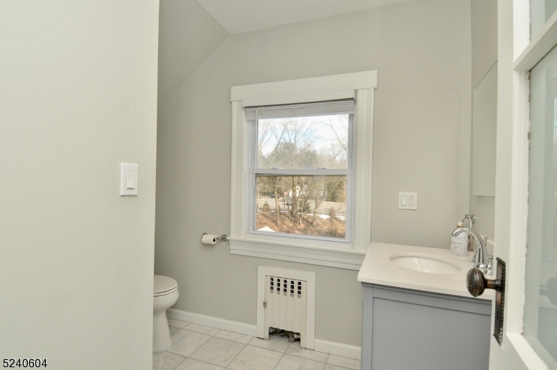 44 Dunnell Road Maplewood, NJ 07040 - Photo 17 of 17 a bathroom with a window a sink and a toilet