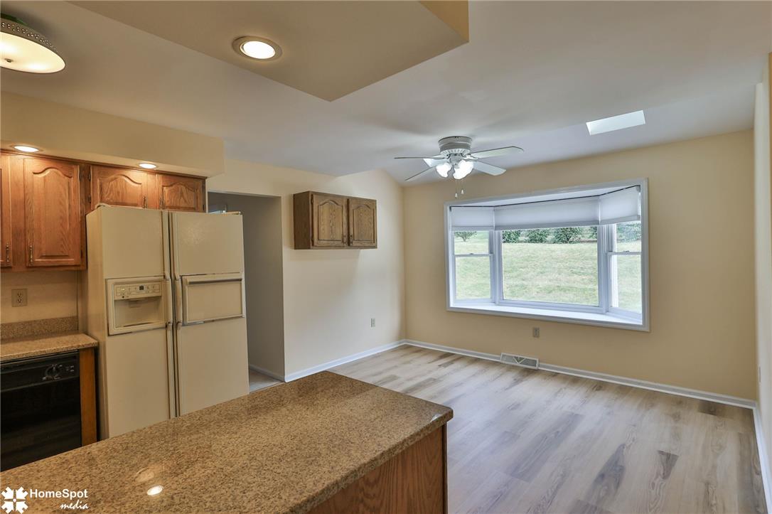4059 Wedgewood Road Allentown, PA 18104 - Photo 8 of 72 Kitchen and dining area with modern flooring and sun-filled bay window overlooking the yard.