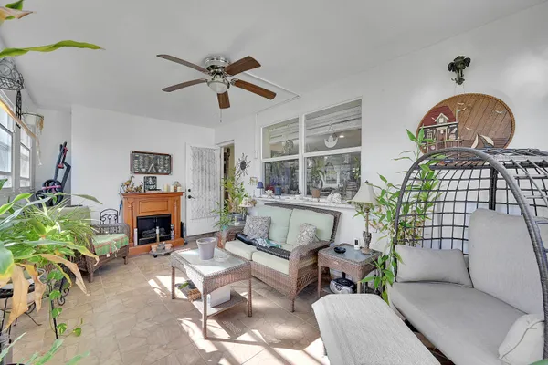 a living room with furniture a fireplace and a potted plant