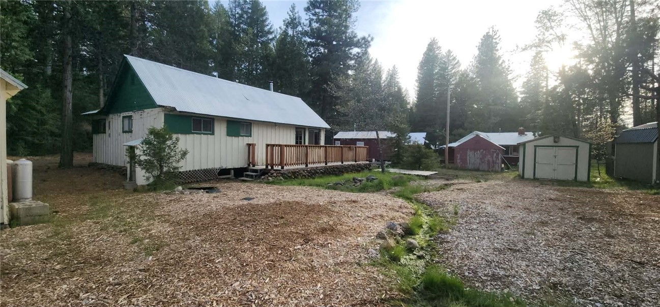 a view of a house with a yard and sitting area