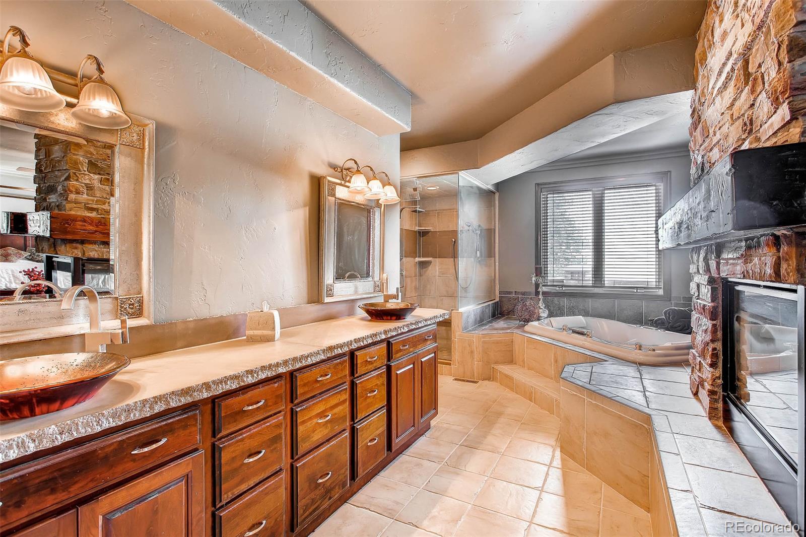 15241 Shadow Mountain Ranch Road Larkspur, CO 80118 - Photo 16 of 31 a large bathroom with a large tub and sink