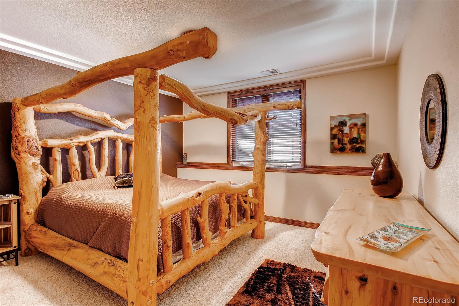 15241 Shadow Mountain Ranch Road Larkspur, CO 80118 - Photo 24 of 31 a bedroom with two beds and white walls