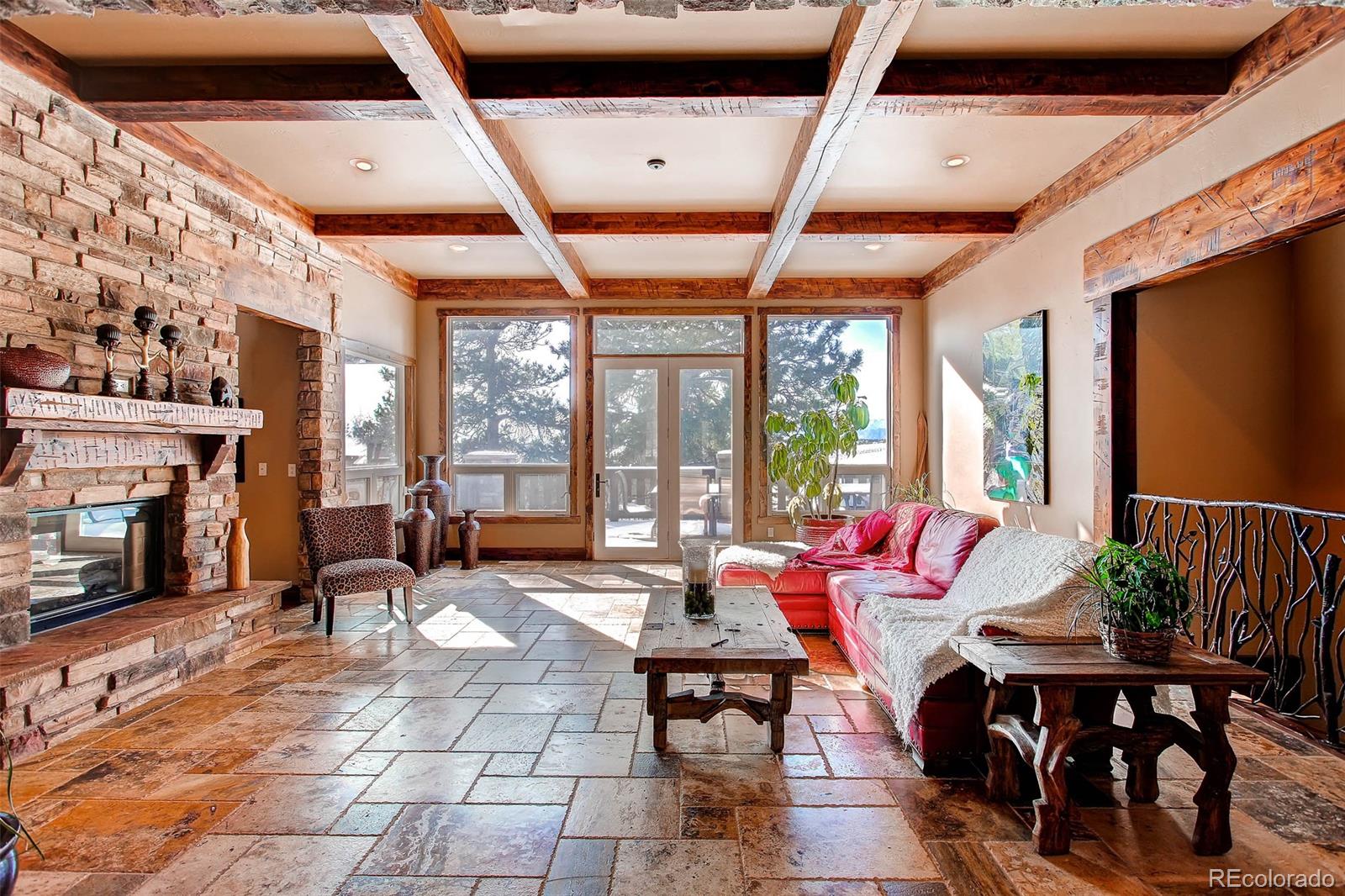15241 Shadow Mountain Ranch Road Larkspur, CO 80118 - Photo 4 of 31 a living room with fireplace furniture and a large window