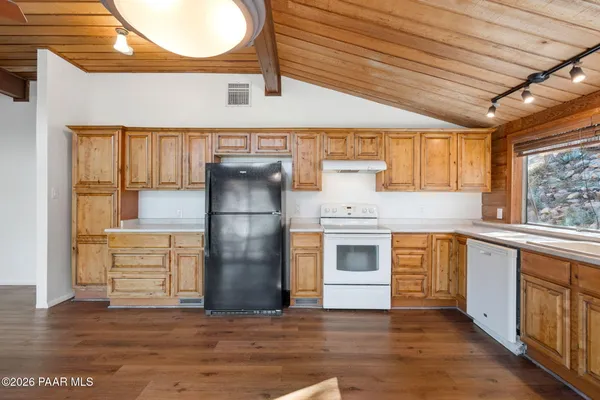 a kitchen with a refrigerator and a stove